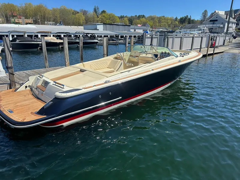 Slide: The Image of 2016 Chris-Craft Launch 28 boat docked in a marina, featuring elegant design and spacious seating. - 8