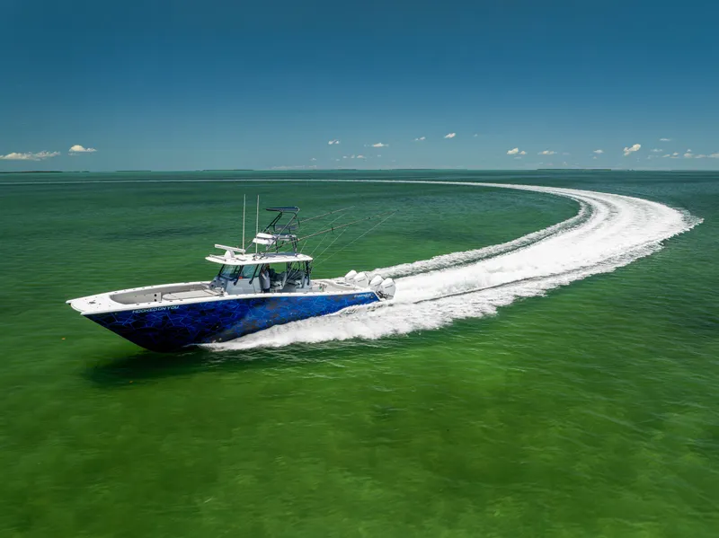 Slide: The Image of Freeman 42 LR boat cruising on green water, 2021 model, creating a sweeping wake. - 10