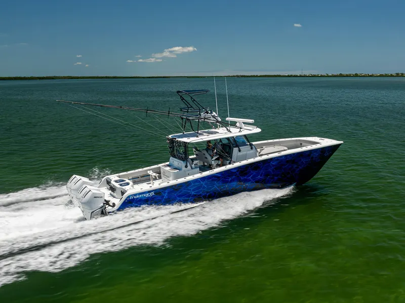 Slide: The Image of 2021 Freeman 42 LR boat cruising on open water, side view. - 13