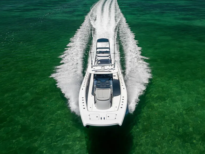 Slide: The Image of Aerial view of 2021 Freeman 42 LR boat cruising on clear green water. - 14