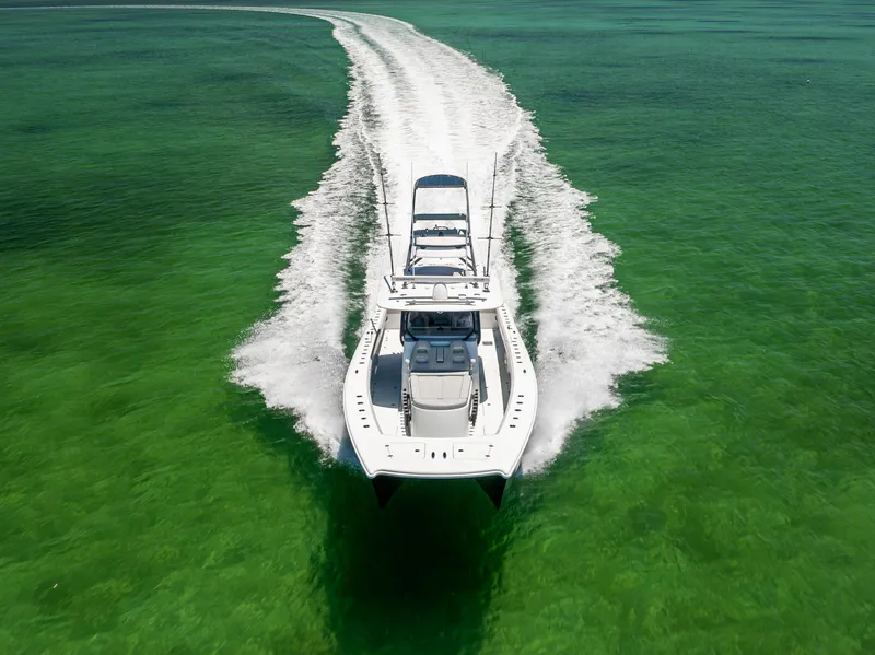 Slide: The Image of Freeman 42 LR boat cruising on clear green water, aerial view, 2021 model. - 15