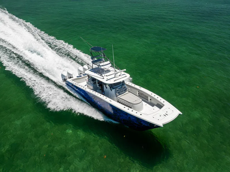 Slide: The Image of Freeman 42 LR 2021 boat cruising on clear green water, aerial view. - 16