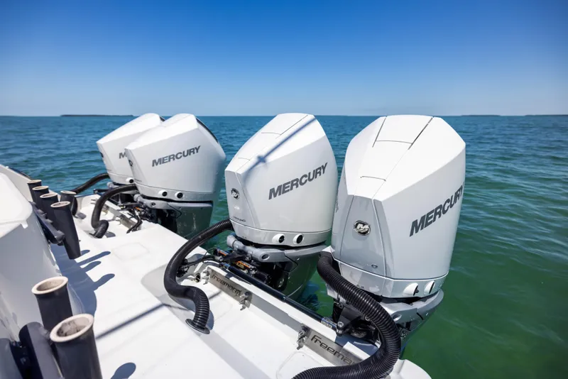 Slide: The Image of Three Mercury outboard engines on a 2021 Freeman 42 LR boat in open water. - 20
