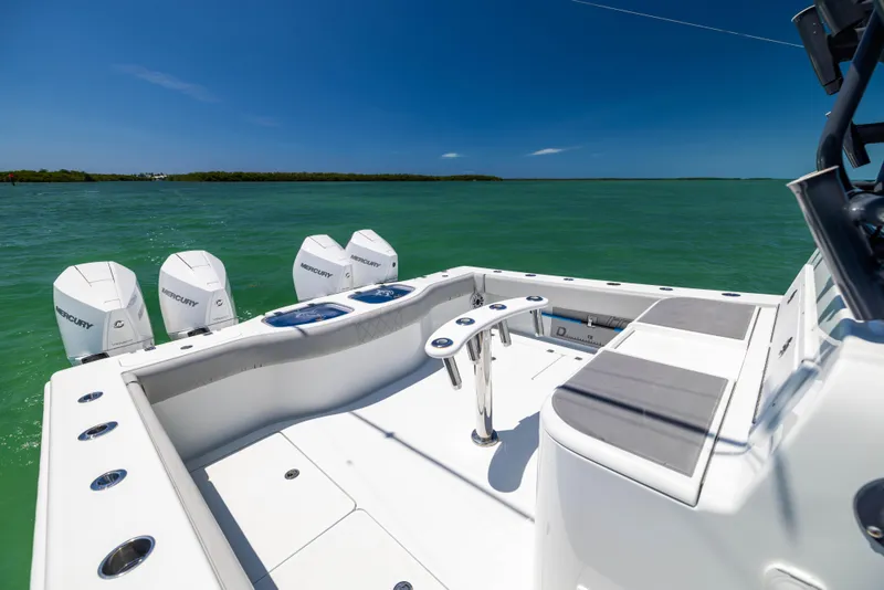 Slide: The Image of 2021 Freeman 42 LR boat with quad engines on turquoise water. - 22