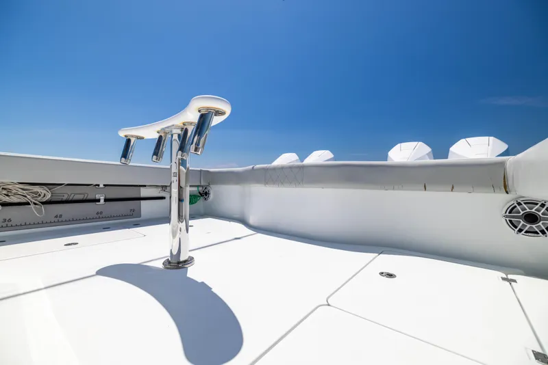 Slide: The Image of Freeman 42 LR 2021 boat deck with rod holders under clear blue sky. - 24