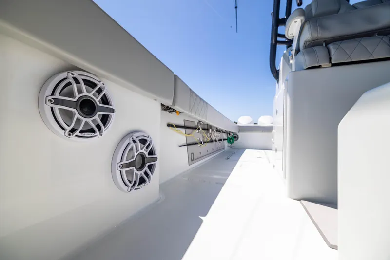 Slide: The Image of 2021 Freeman 42 LR boat interior with speakers and fishing rod holders. - 27