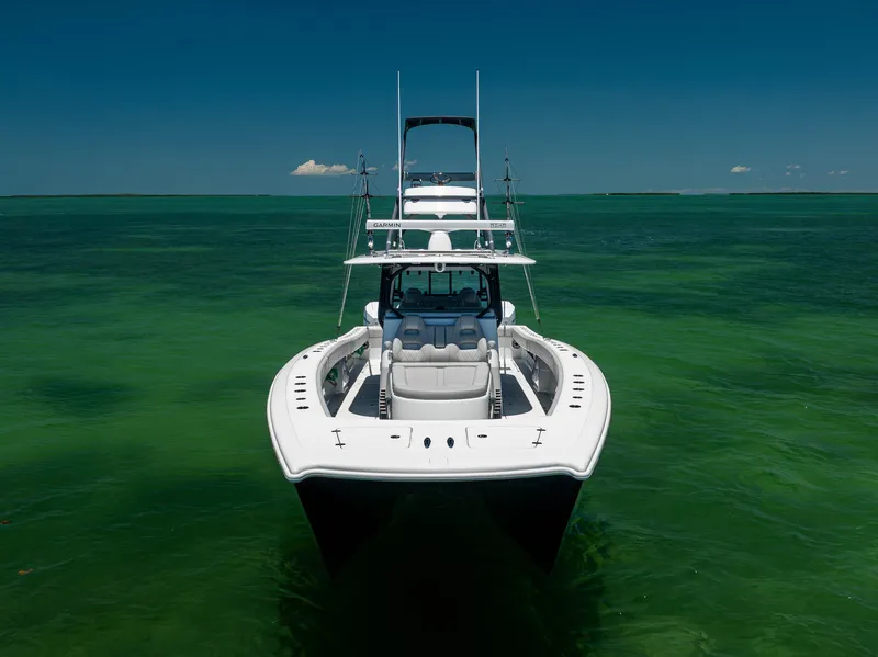 Slide: The Image of Freeman 42 LR 2021 boat on clear green water under blue sky. - 3