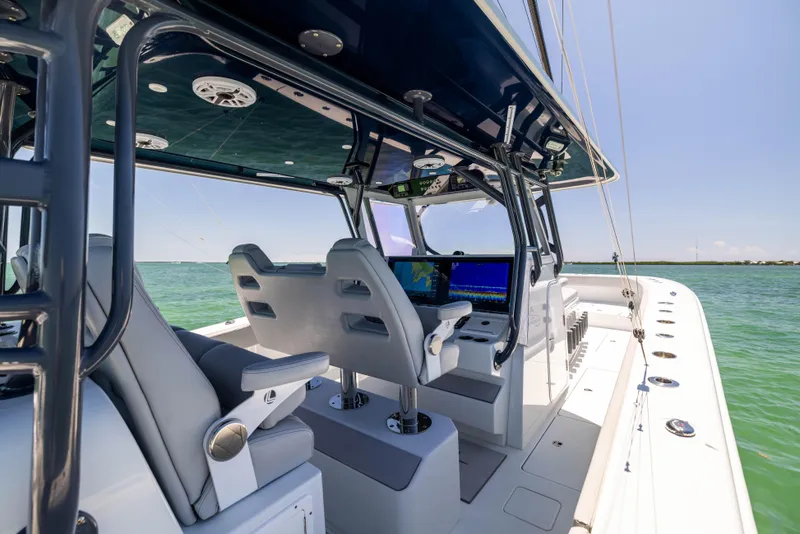 Slide: The Image of 2021 Freeman 42 LR boat interior with modern helm and seating, cruising on open water. - 31