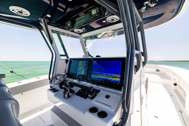 Slide: The Image of 2021 Freeman 42 LR boat cockpit with advanced navigation screens and controls. - 35