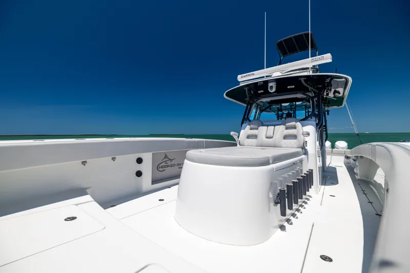 Slide: The Image of 2021 Freeman 42 LR boat with sleek design and spacious deck under clear blue sky. - 47