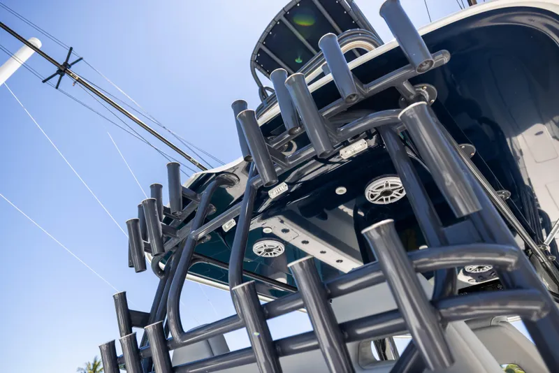 Slide: The Image of 2021 Freeman 42 LR boat with rod holders and speakers, viewed from below against blue sky. - 48