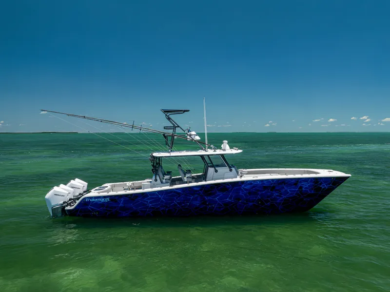 Slide: The Image of 2021 Freeman 42 LR boat on calm green sea under clear blue sky. - 6