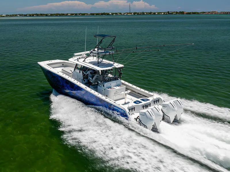 Slide: The Image of 2021 Freeman 42 LR boat cruising on open water, showcasing powerful engines and sleek design. - 8