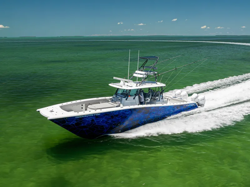 Slide: The Image of 2021 Freeman 42 LR boat cruising on clear green water, under a bright blue sky. - 9