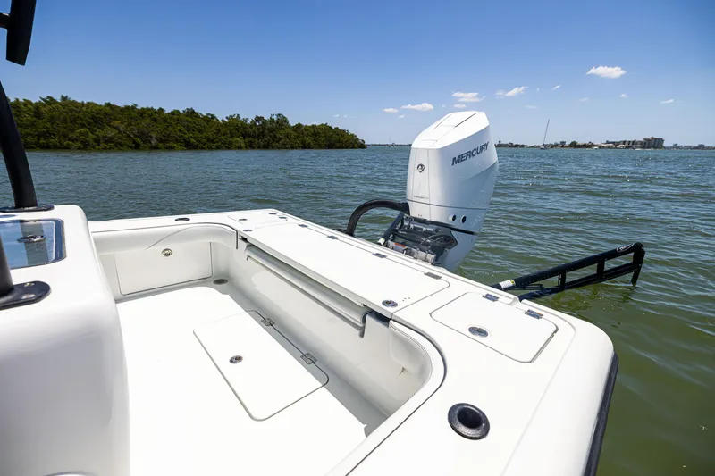 Slide: The Image of 2020 Barker Boatworks 26 with Mercury engine on calm water, clear sky background. - 11