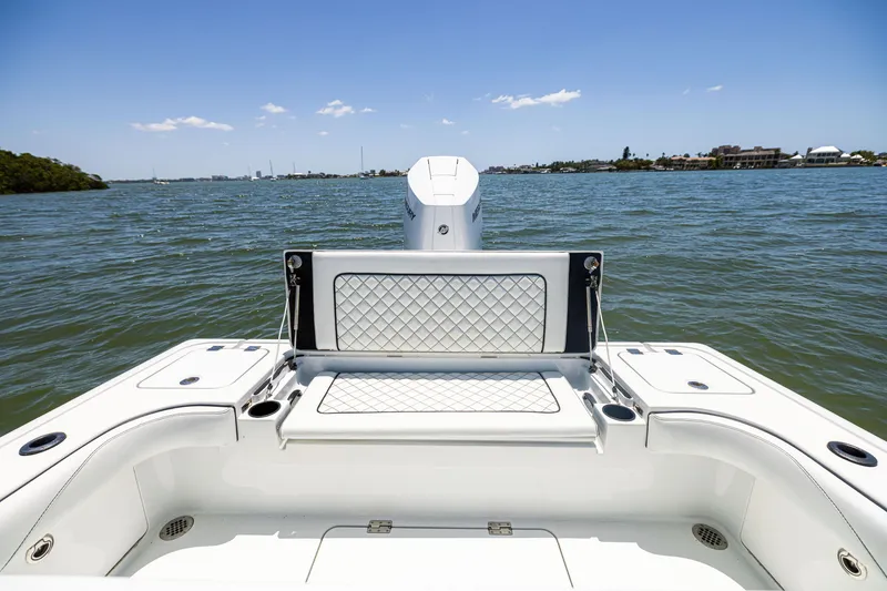 Slide: The Image of 2020 Barker Boatworks 26, rear view on water, featuring cushioned seating and rod holders. - 12