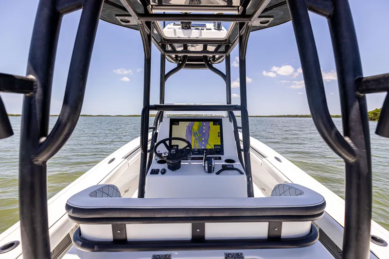 Slide: The Image of 2020 Barker Boatworks 26 center console on water, featuring navigation system and steering wheel. - 13