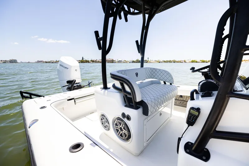 Slide: The Image of 2020 Barker Boatworks 26 interior with seating and speakers on a sunny day. - 14
