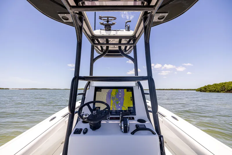 Slide: The Image of 2020 Barker Boatworks 26 helm with navigation system on calm waters. - 16
