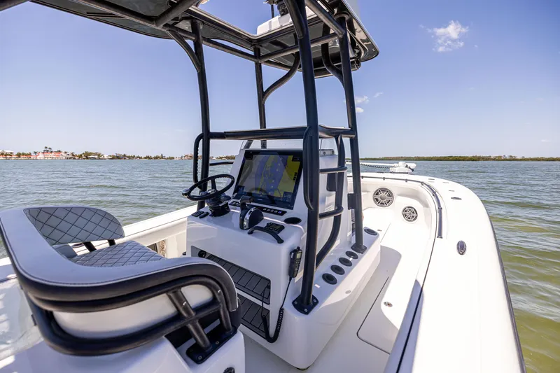 Slide: The Image of 2020 Barker Boatworks 26 center console on calm water, featuring modern navigation equipment. - 18