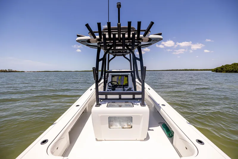 Slide: The Image of 2020 Barker Boatworks 26 on calm water, featuring a sleek design and sturdy T-top. - 19