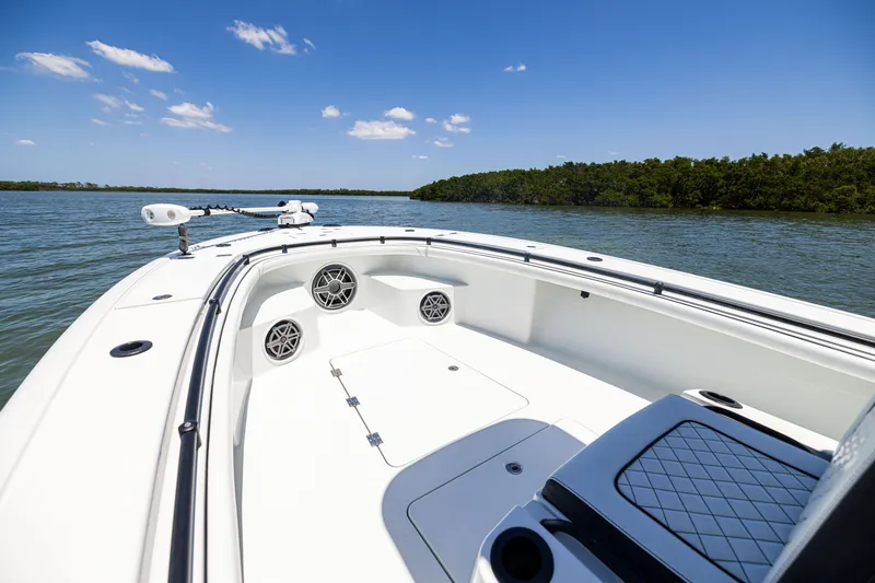 Slide: The Image of 2020 Barker Boatworks 26 on calm water, featuring sleek design and spacious deck. - 22
