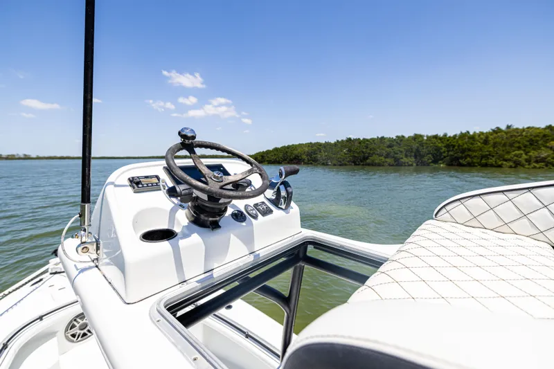 Slide: The Image of 2020 Barker Boatworks 26 helm with scenic water and sky backdrop. - 27