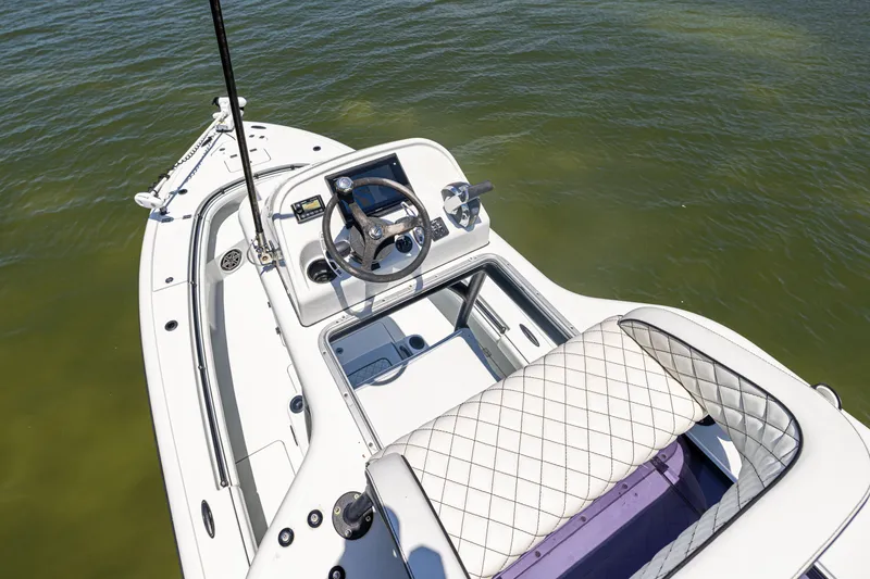 Slide: The Image of 2020 Barker Boatworks 26 model, featuring a sleek helm and quilted seating on calm water. - 29