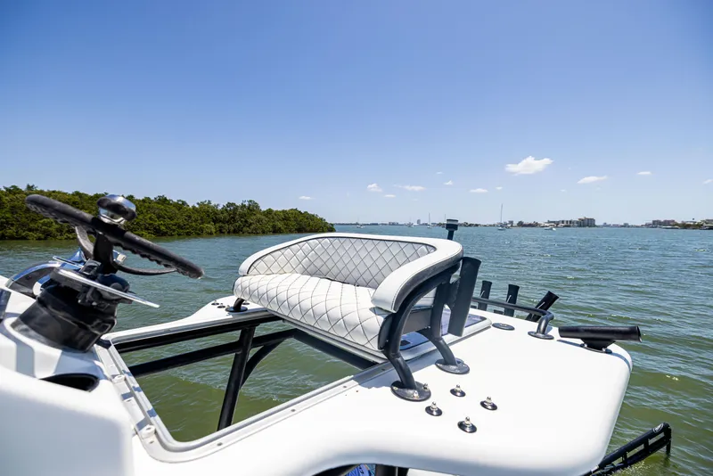 Slide: The Image of 2020 Barker Boatworks 26 on water, featuring elevated seating and steering wheel. - 32