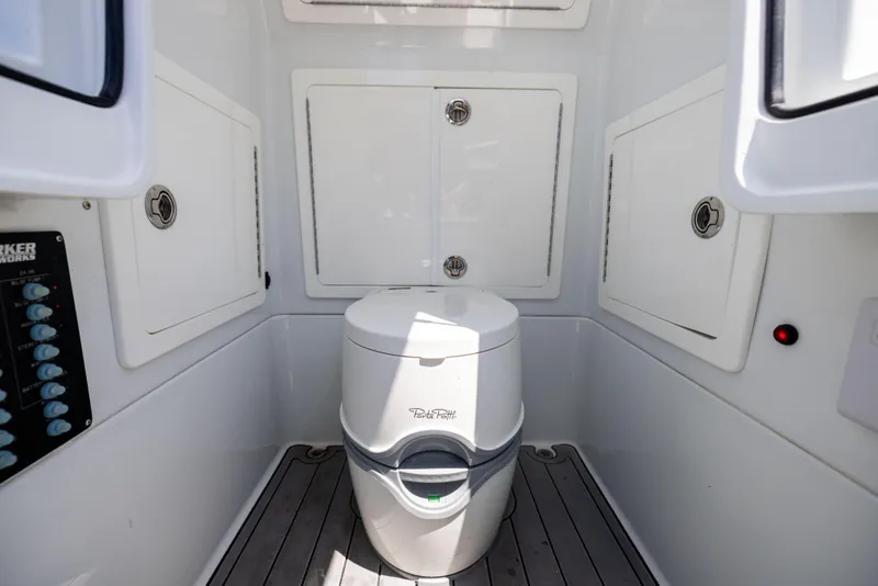 Slide: The Image of 2020 Barker Boatworks 26 interior with marine toilet and storage compartments. - 33