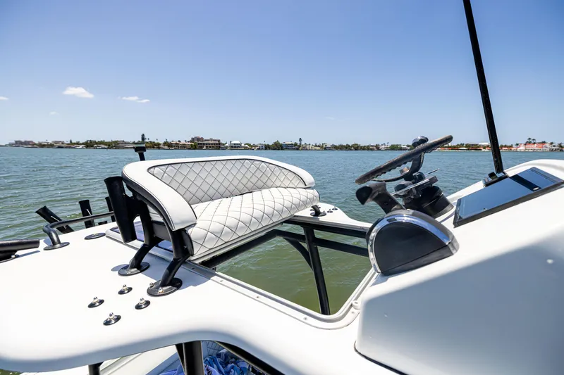 Slide: The Image of 2020 Barker Boatworks 26 helm with luxurious seating, steering wheel, and scenic water view. - 34