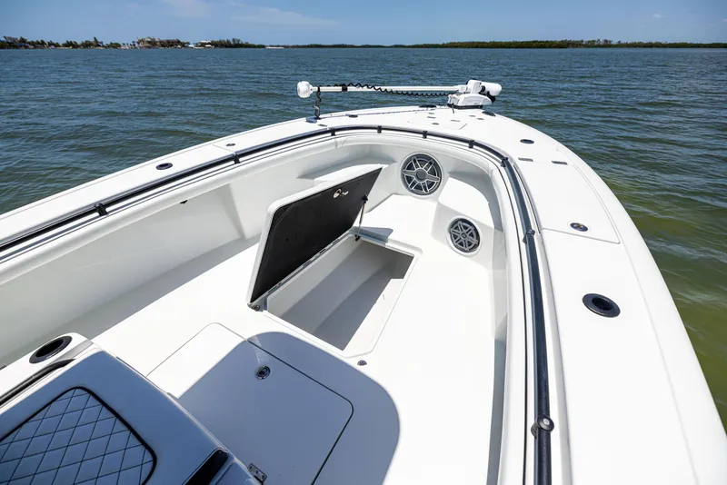 Slide: The Image of 2020 Barker Boatworks 26 on water, open storage compartment, sunny day. - 35