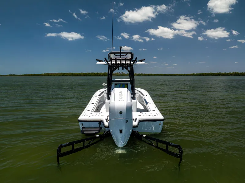 Slide: The Image of 2020 Barker Boatworks 26 on water, clear sky, rear view. - 6