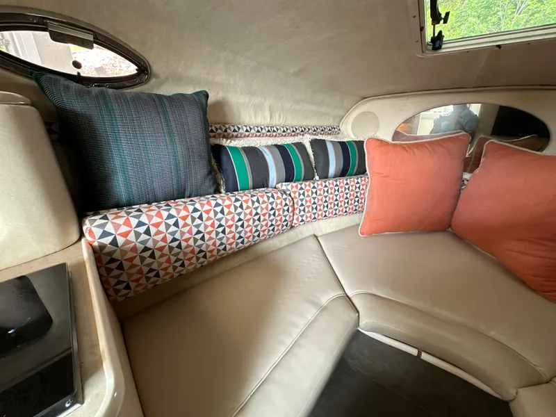 Slide: The Image of Interior of 2002 Sea Ray 240 Sundancer with colorful cushions and seating area. - 13