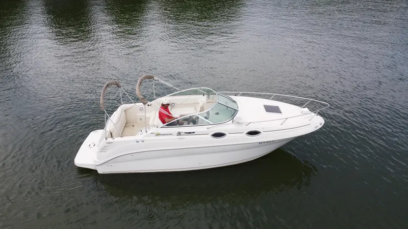 Slide: The Image of 2002 Sea Ray 240 Sundancer boat on calm water, side view. - 3