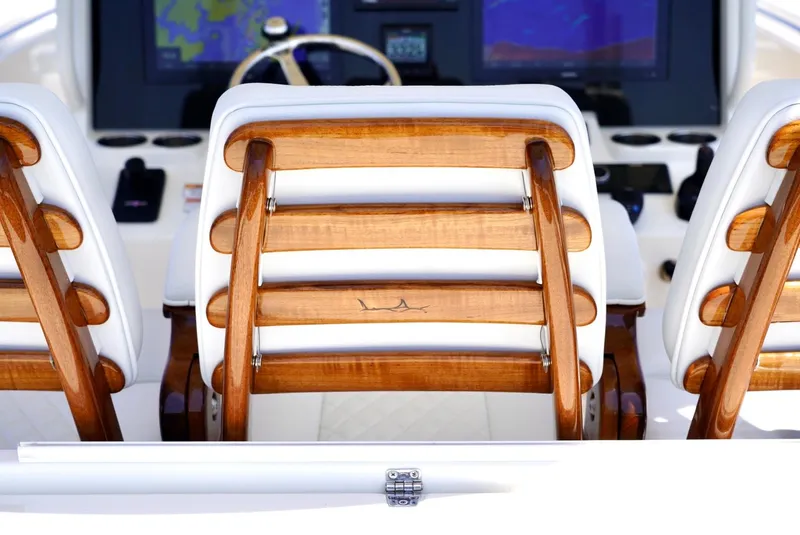 Slide: The Image of 2020 Cobia 350 Center Console boat with wooden seating and navigation display. - 12