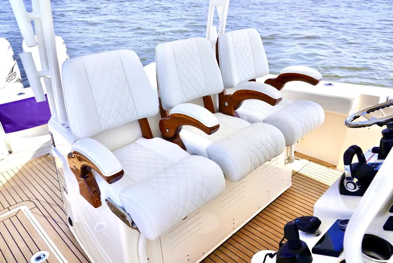 Slide: The Image of Luxurious seating on 2020 Cobia 350 Center Console boat with white upholstery. - 13