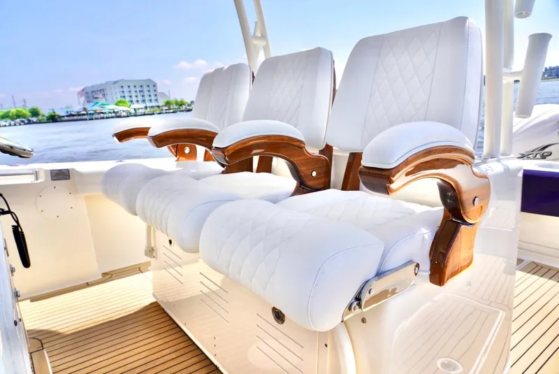 Slide: The Image of Luxurious seating on 2020 Cobia 350 Center Console boat with waterfront view. - 15