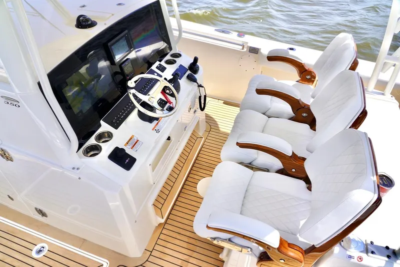 Slide: The Image of 2020 Cobia 350 Center Console boat interior with helm and luxurious seating. - 17