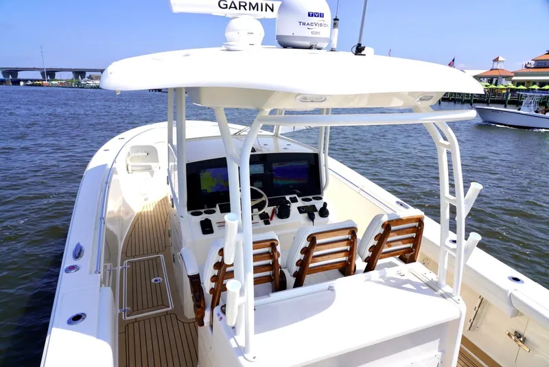 Slide: The Image of 2020 Cobia 350 Center Console boat with advanced navigation system on calm waters. - 19