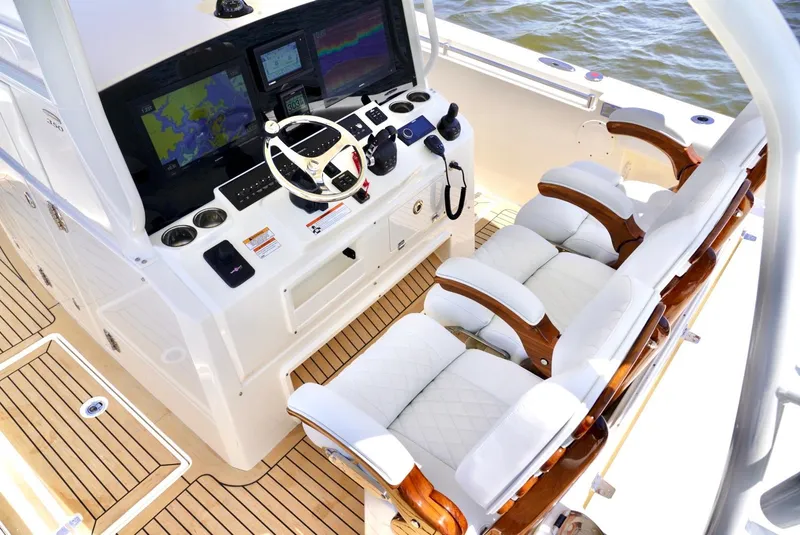 Slide: The Image of 2020 Cobia 350 Center Console boat cockpit with advanced navigation system and luxurious seating. - 20