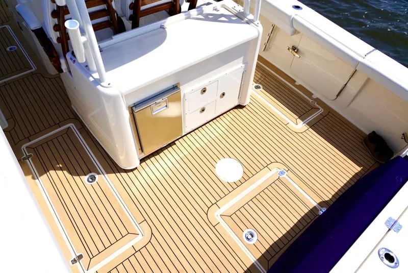Slide: The Image of 2020 Cobia 350 Center Console boat deck with storage compartments and seating. - 21