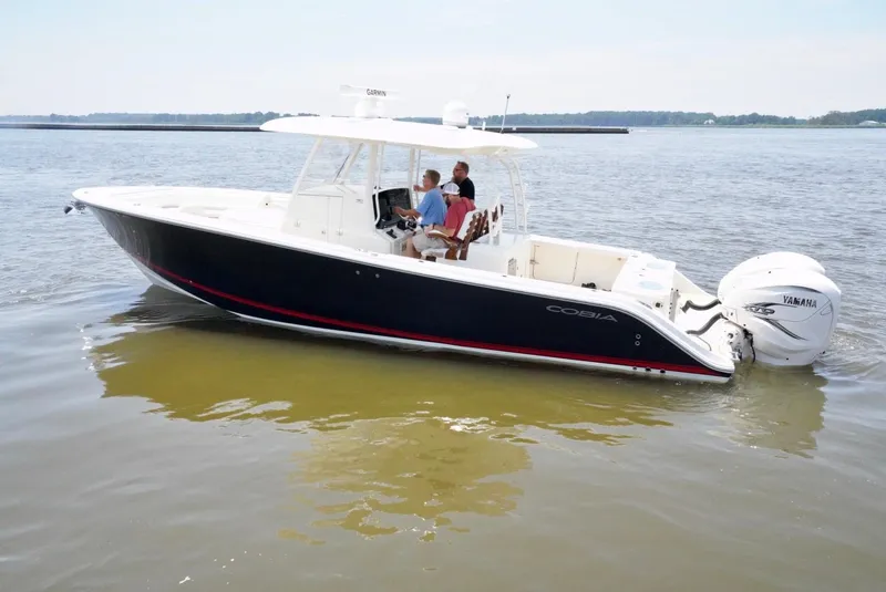 Slide: The Image of 2020 Cobia 350 Center Console boat on calm water, featuring dual Yamaha outboard engines. - 5