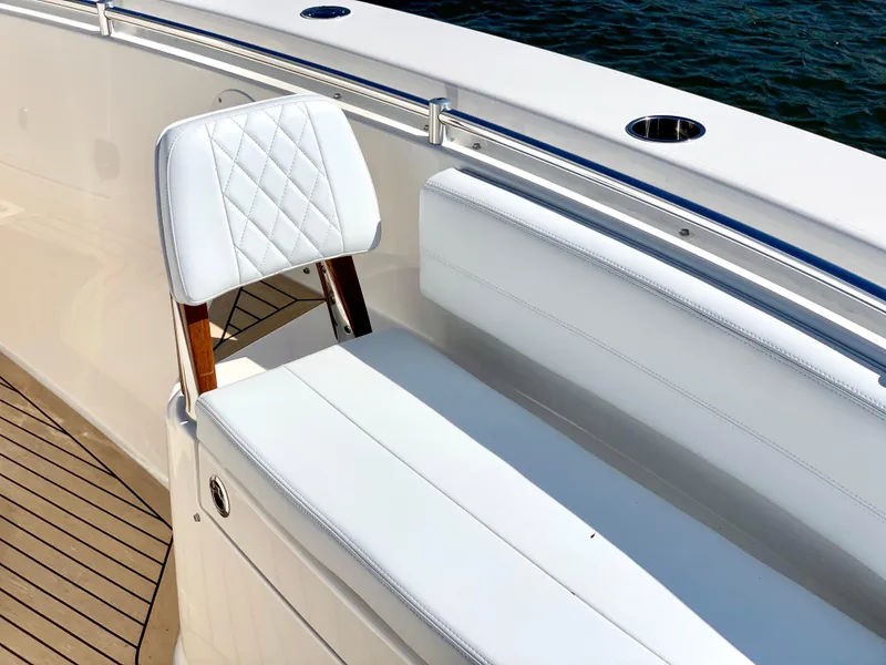 Slide: The Image of 2020 Cobia 350 Center Console boat with white seating and wooden accents. - 9