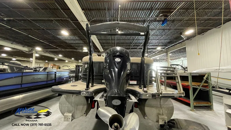 Slide: The Image of 2020 Berkshire STS Entertainment 25 pontoon boat in showroom, rear view with motor. - 10