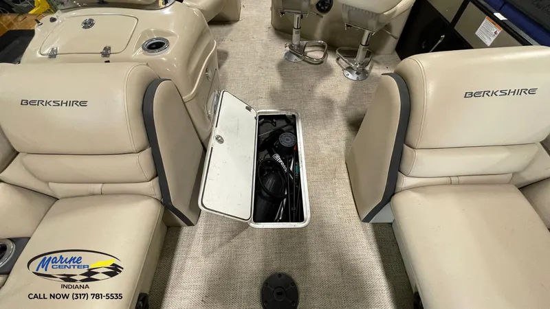 Slide: The Image of Interior of 2020 Berkshire STS Entertainment 25 boat with open storage compartment. - 12