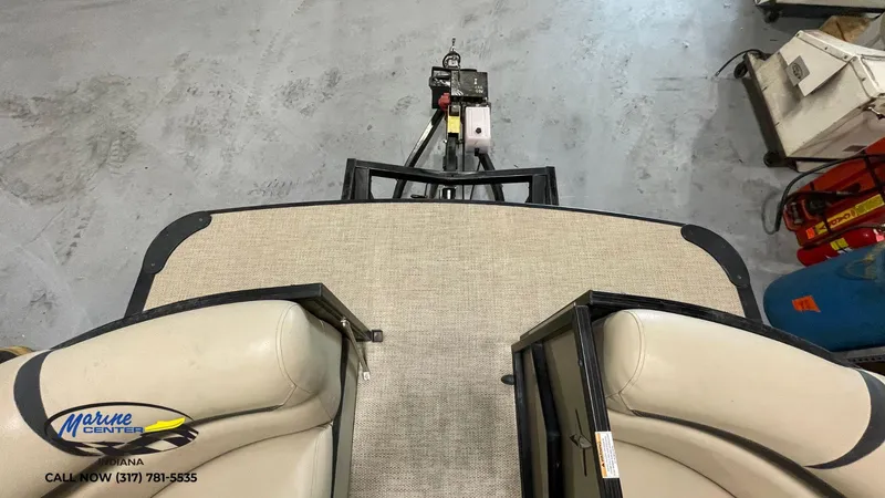 Slide: The Image of 2020 Berkshire STS Entertainment 25 boat interior with beige seating and Marine Center logo. - 14