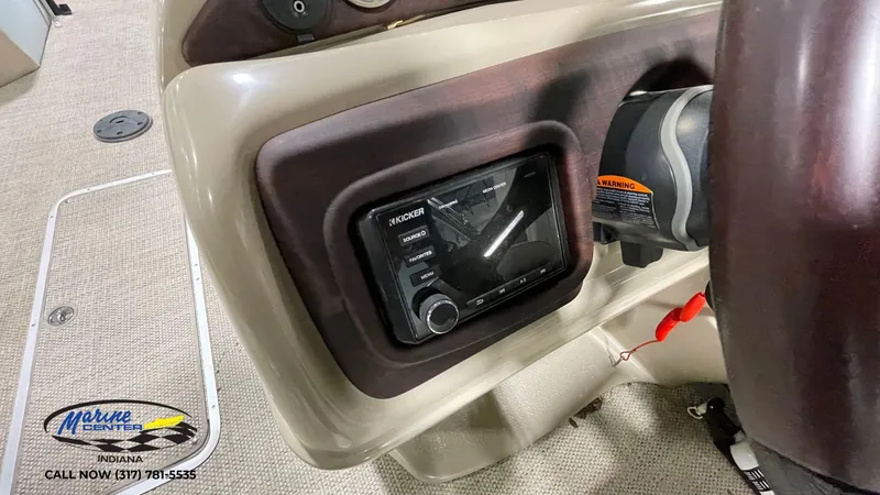 Slide: The Image of 2020 Berkshire STS Entertainment 25 dashboard with Kicker audio system and steering wheel. - 18