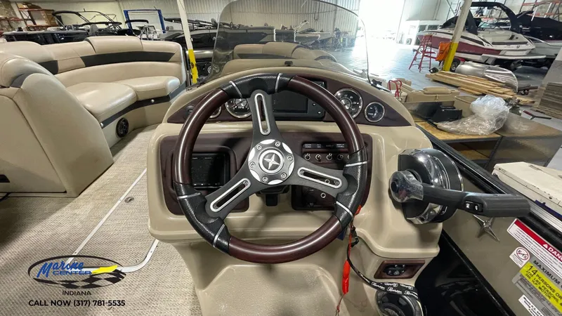 Slide: The Image of Steering console of a 2020 Berkshire STS Entertainment 25 pontoon boat in a showroom. - 19