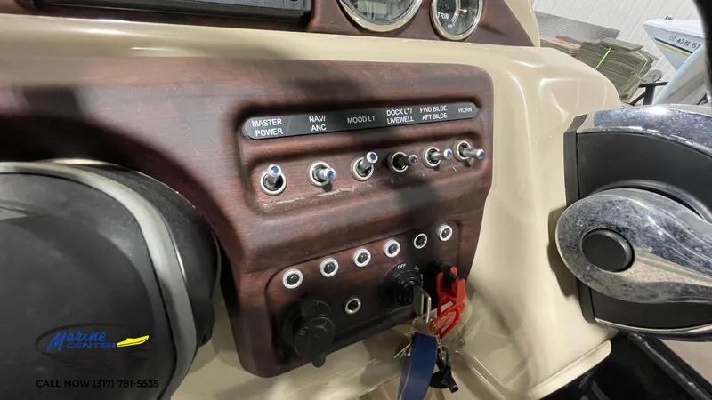 Slide: The Image of Control panel of a 2020 Berkshire STS Entertainment 25 boat with labeled switches. - 20